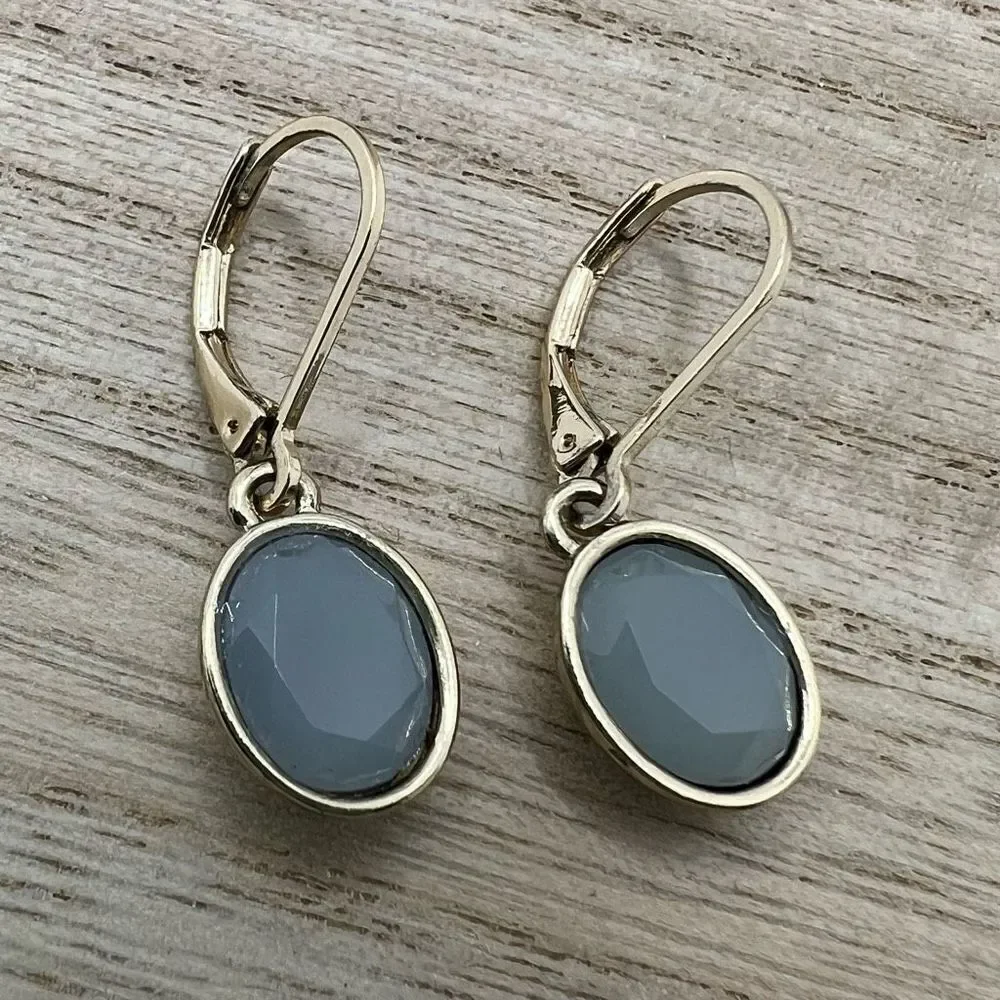 Faceted blue grey hinge dangle earrings on gold tone backing